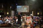 Jeremy Borum conducting the orchestra for Gosnell film score